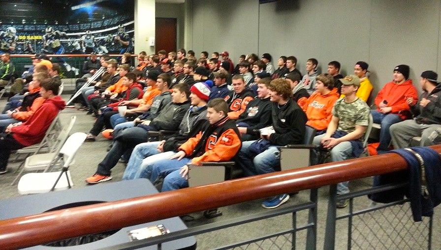 The Gillespie Miner football team is awarded the St. Louis Rams high school football team of the year. They pay attention to the ceremony. 