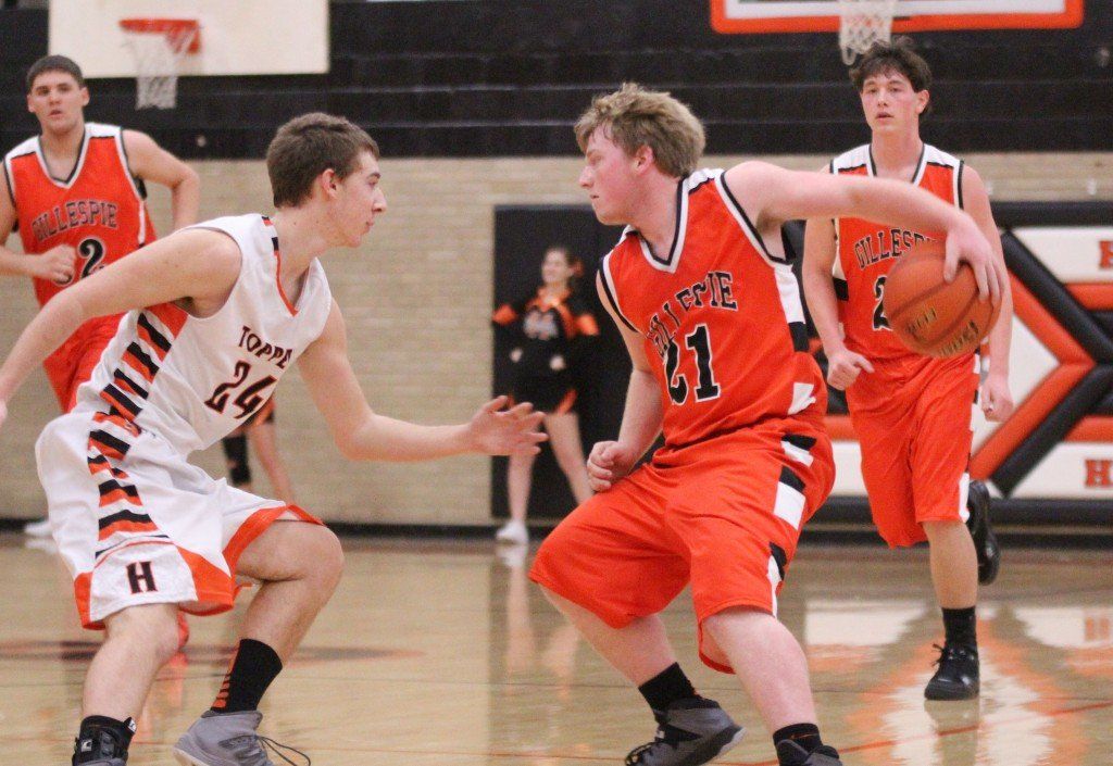 Eli Fox fakes his opponent by dribbling around his back in Tuesday's matchup with Hillsboro. The boys fell 46-83.