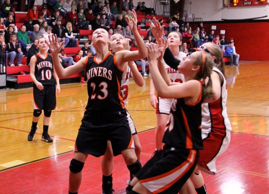 Bailey Jarman and Amanda Schmidt wait for the rebound in the Lady Miners' loss to Bunker Hill.