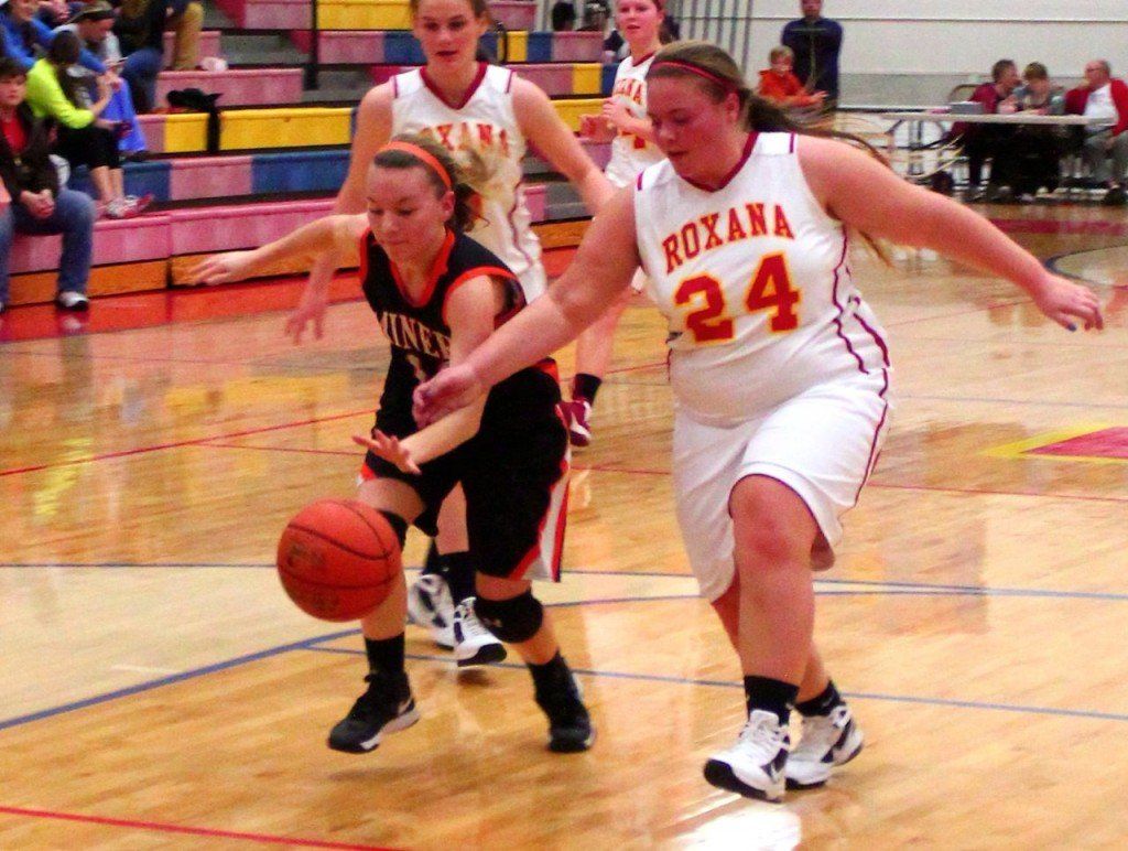 Tyler Ross beats her opponent from Roxana to the basketball in their battle with the Shells this week. The girls beat Roxana 71-57;