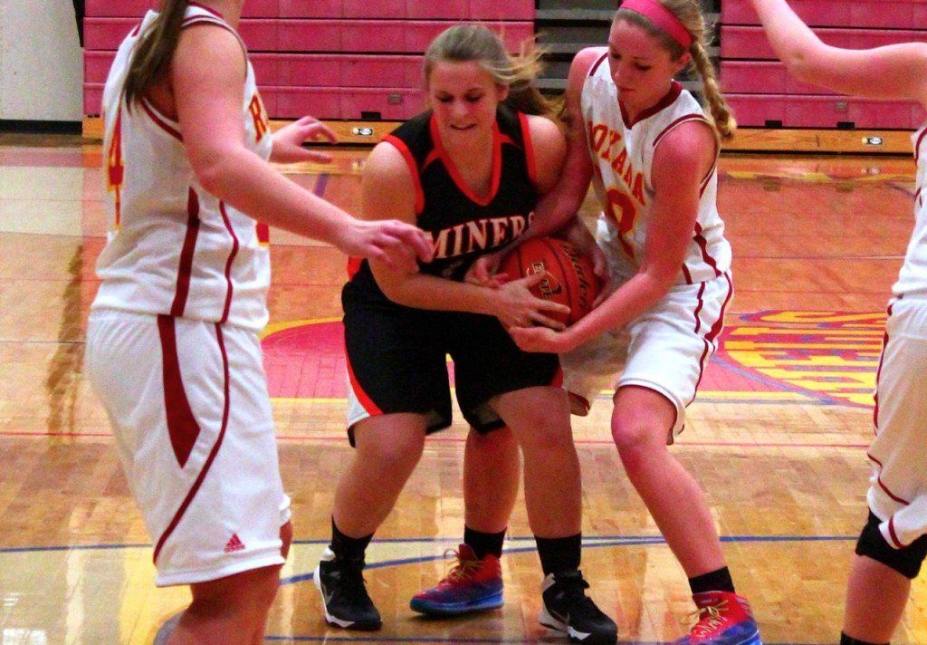 Maddie Bierbaum fights for possession of the ball in Monday's game versus Roxana. The girls won 71-57.