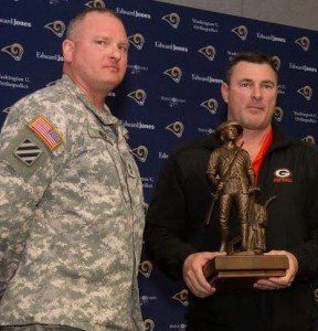 Coach Borgini presented with National Guard Minuteman Statue by Army National Guard Representative SFC Reif.