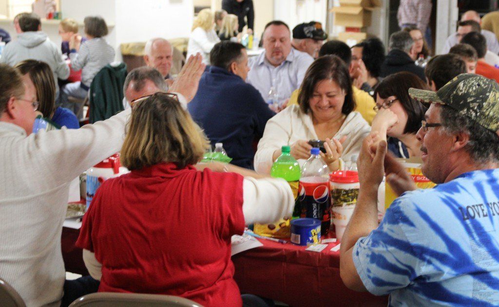 The snowfall didn't put a damper on the Partnership for Education's annual trivia night. Above, Dave Griffel offers Julie Spencer a high five after the team figured out the answer. 