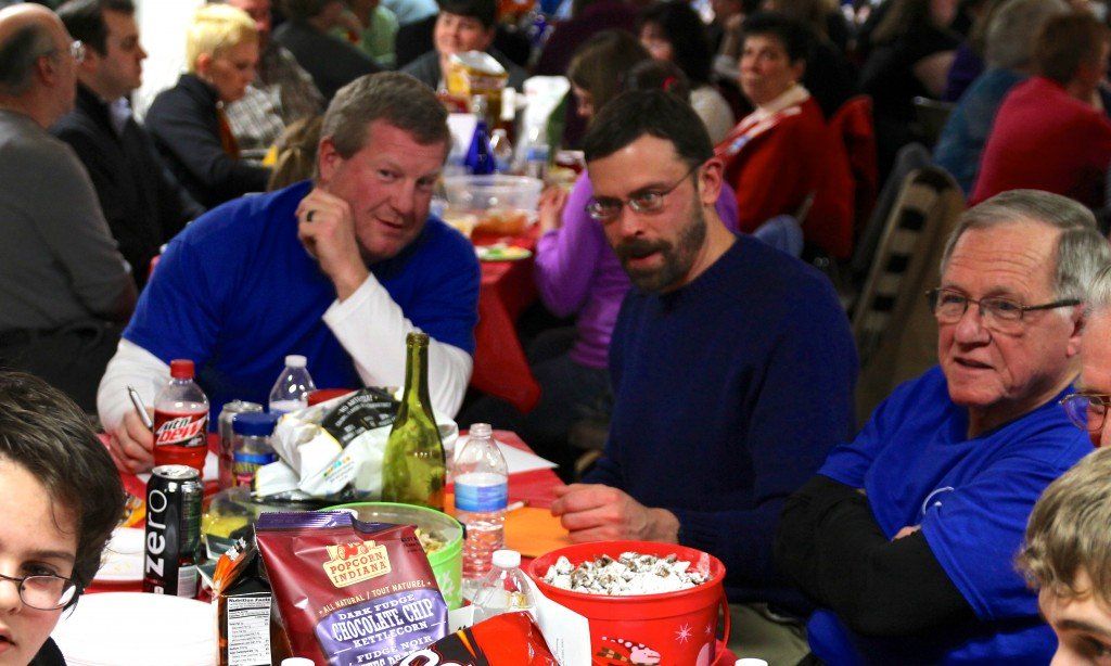 David Schwartz and Kevin Polo ask each other if the kids on their team can answer a Harry Potter question at the Partnership's annual trivia night. 