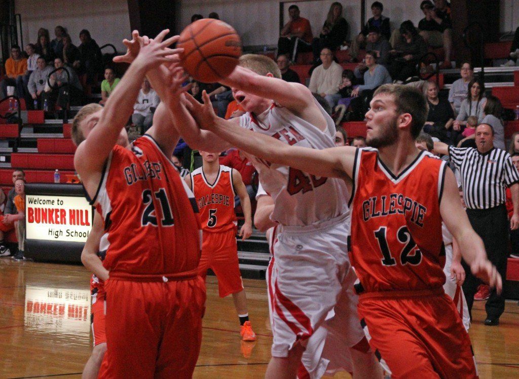 Kirland Davis and Eli Fox battle for a rebound with a Bunker Hill opponent last Tuesday. The Miners lost to the Minutemen 78-82 in overtime. 