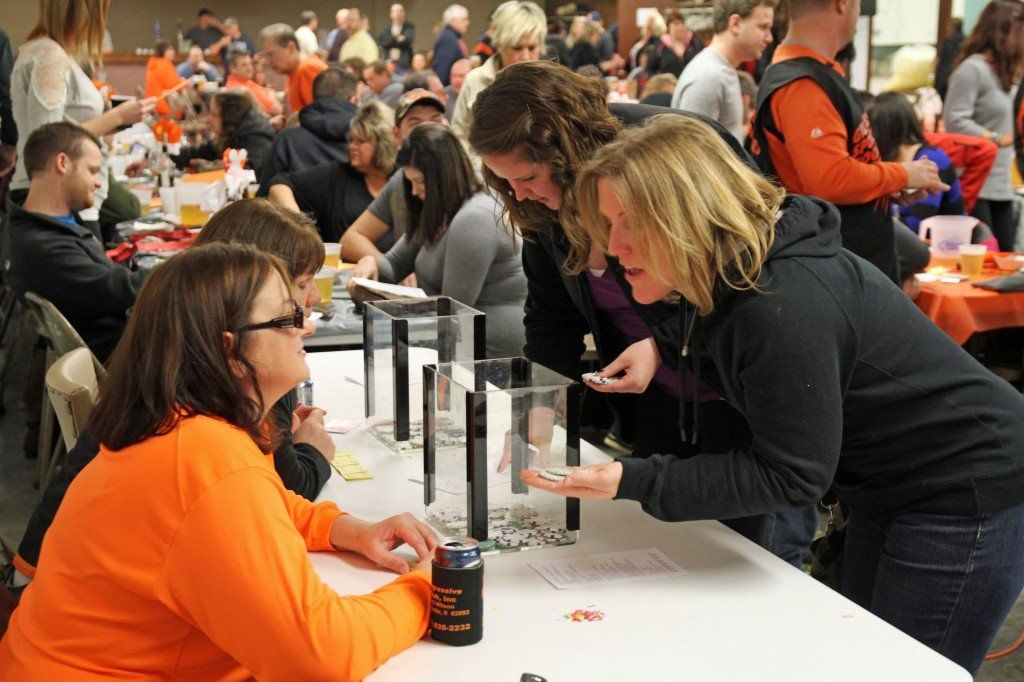 The All-Weather Track Committee held their annual mouse race event Saturday evening at the Benld Civic Center. Pictured above, a patron places her bet at the window. 