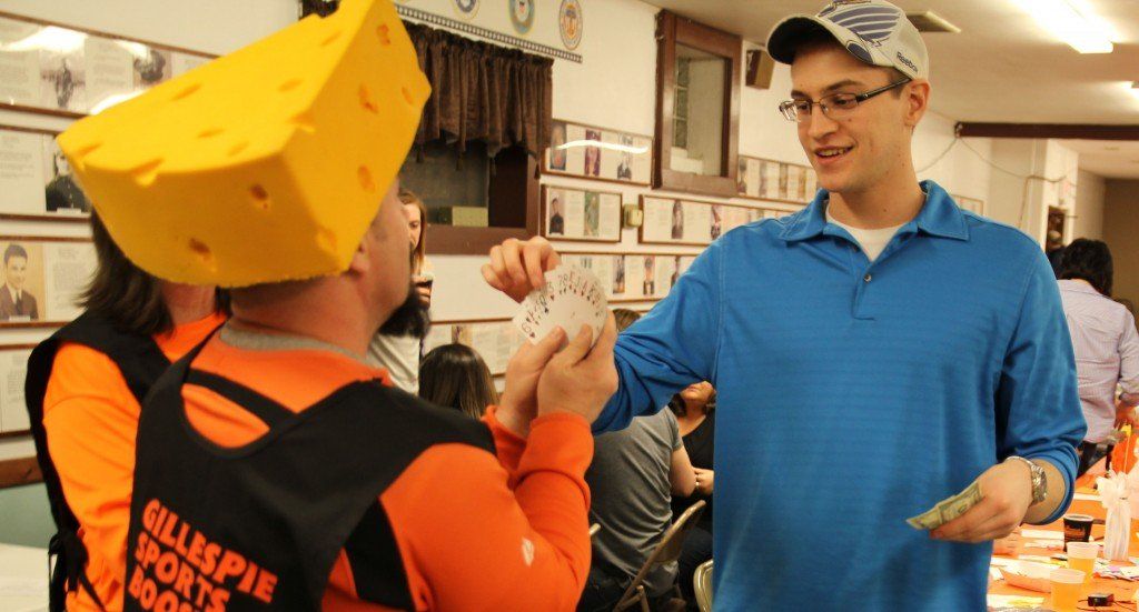 Tim Wargo allows a mouse race participant his choice from the deck of cards for the Mouse Roulette. 