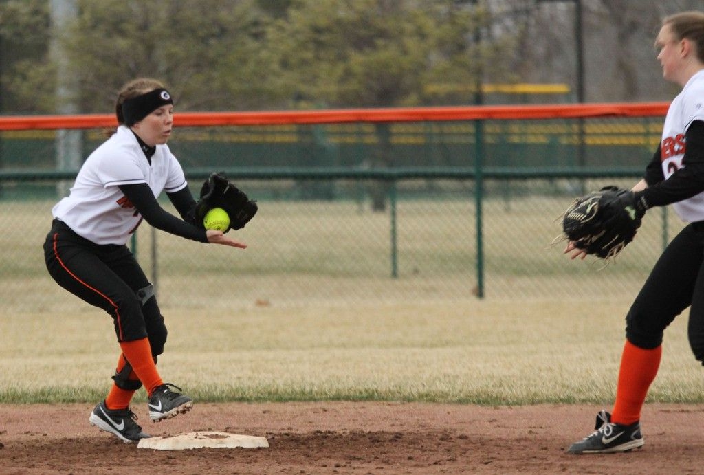 Ally Bires, right, tosses the ball to Molly Gray, left, as the girls combine to turn a double play in Edwardsville Wednesday afternoon. 