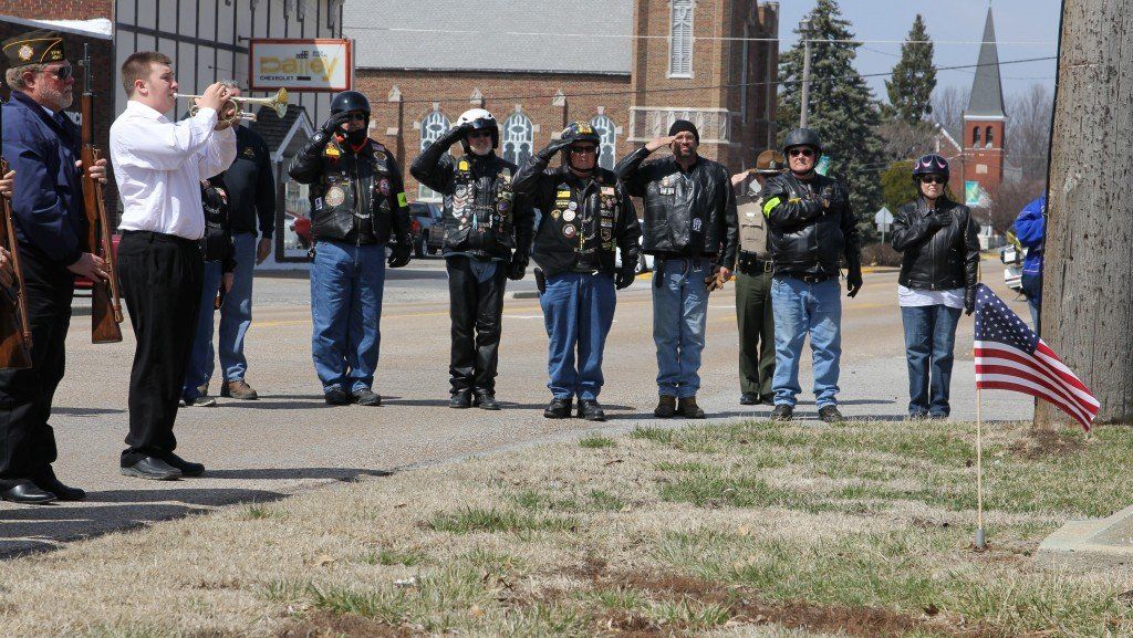 Members of the Illinois Patriot Guard salute as CJ Meno plays taps.