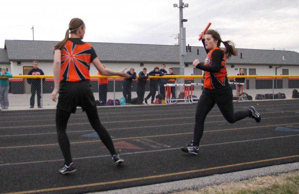 Kelcie Woodring hands the baton off to Sam Alepra in the girls' track meet this week. 