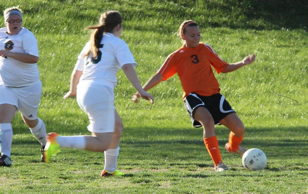 Ty Ross boots the ball past her defender in Friday's 1-0 victory over Metro East Lutheran High School. 