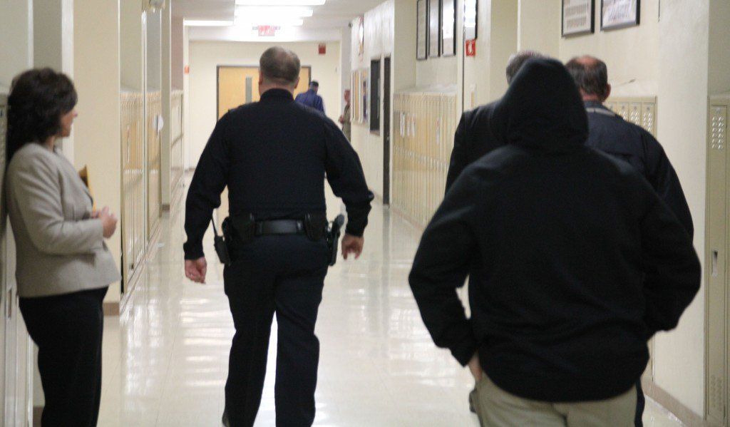 The Gillespie Police Department walk down the high school highway as school board member Jenni Alepra monitors the exercise. 