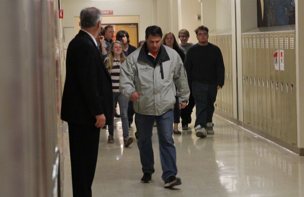 High school instructor Jerry Rosentreter leads his class out of the building. 