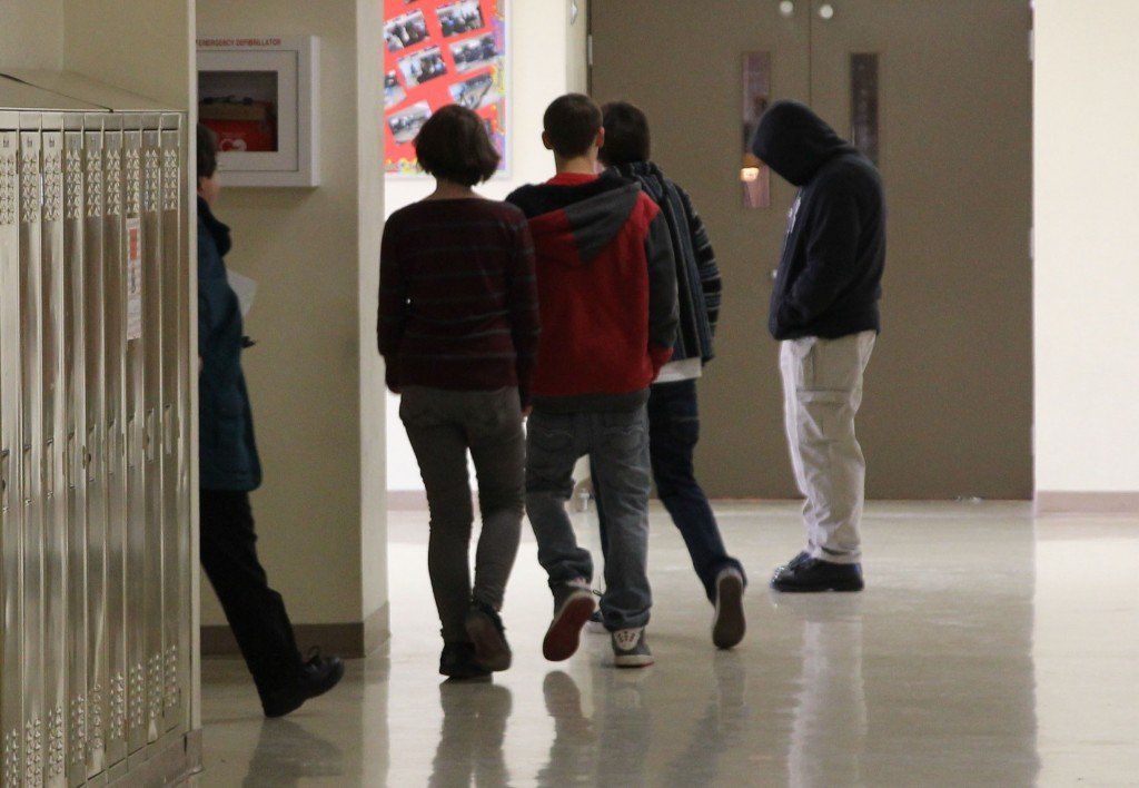 High school students evacuate from the upstairs as gunman actor, Officer Bradford, stands in the hall.