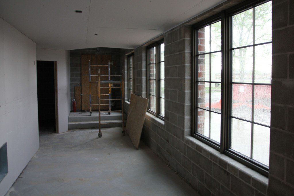 A corridor between the gymnasium and north exit leads to bathrooms on the sides of the gym. 