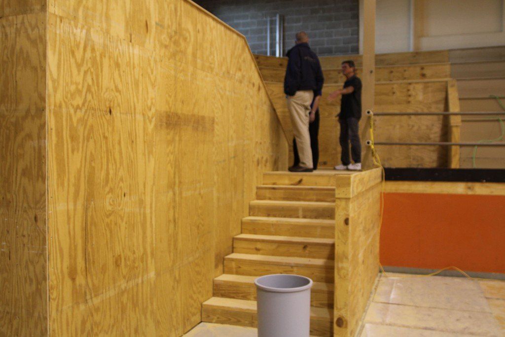 The east and west rising stair cases were replaced with stair cases running parallel to the out of bounds line. 