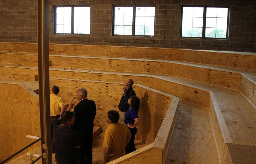 Board members review the new floor plan adding additional seating in the corners of the gym without the stair cases. 