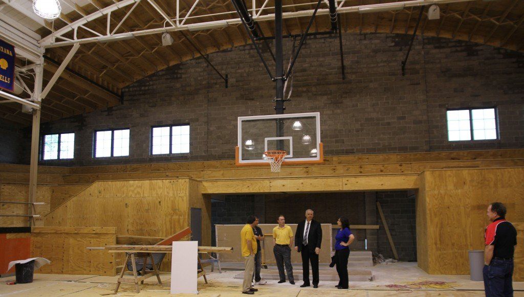 A view from mid-court looking at the north wall with board members congregating about the changes. 