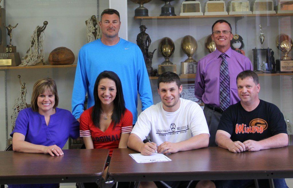 Logan Cooper (middle) signing his letter of intent while parents, girlfriend, Coach Borgini and athletic director Mike Bertagnolli look on. 