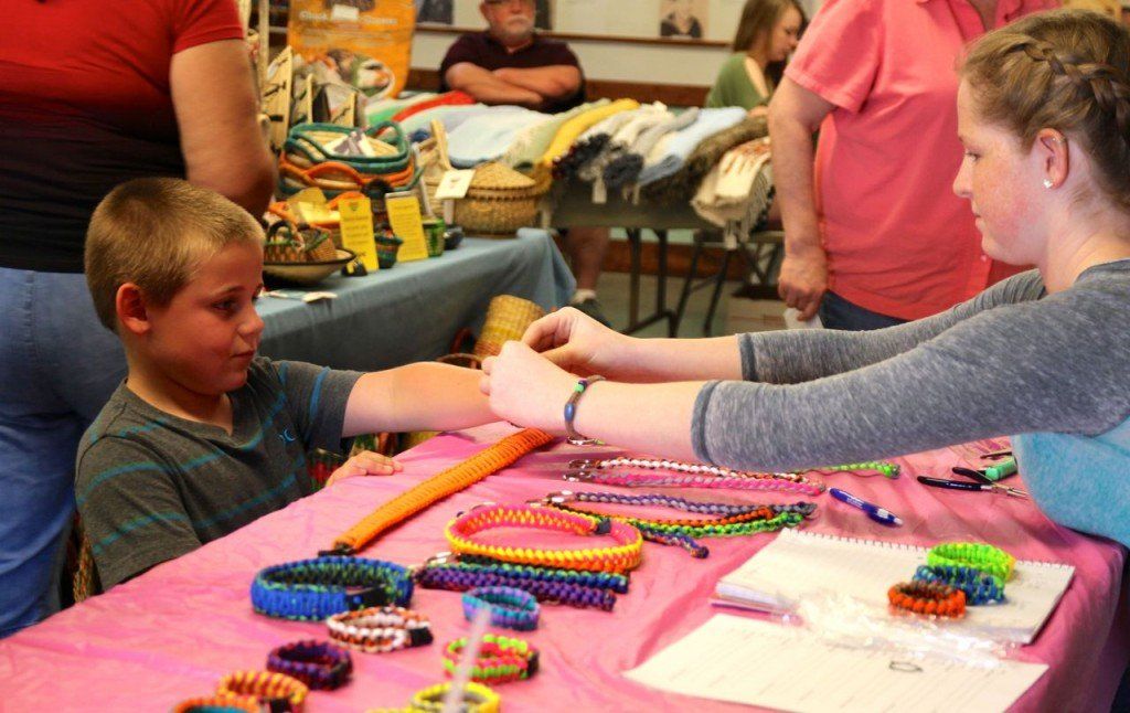 Bracelet maker Kaily Frensko sizes a bracelet for Brock Sherman at the annual Build Benld Craft Fair. 