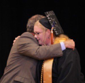 Shelby Heyen gives Rick Spencer a hug after receiving the FFA Alumni Scholarship.