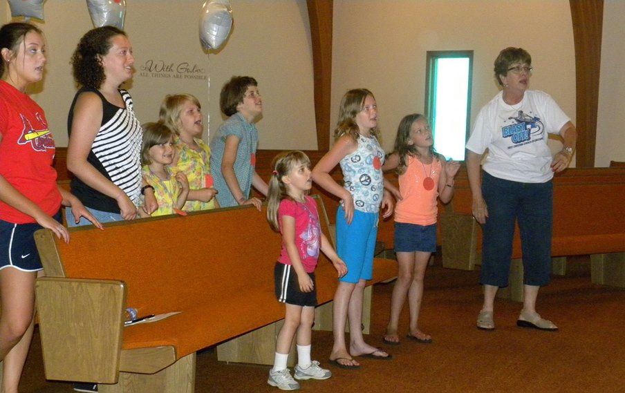 First Christian Church of Gillespie started their vacation bible school Friday and will wrap it up this morning at their church service. Above, Caroline Scheller leads her song in a class. 