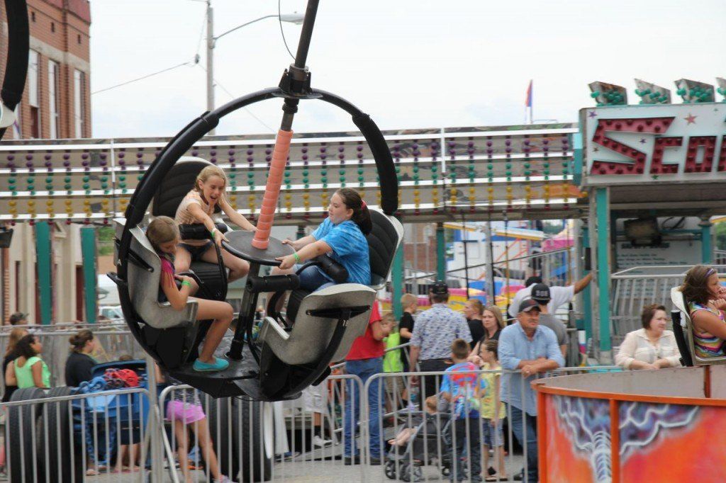 Youngsters try and spin the wheel to make their ride spin faster. 