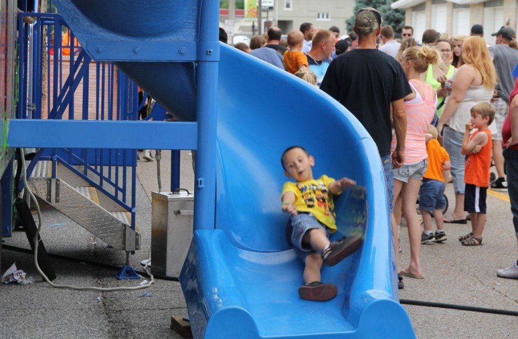 A kid comes barreling down the slide on the newest attraction to the carnival this year, the Wacky Shack.