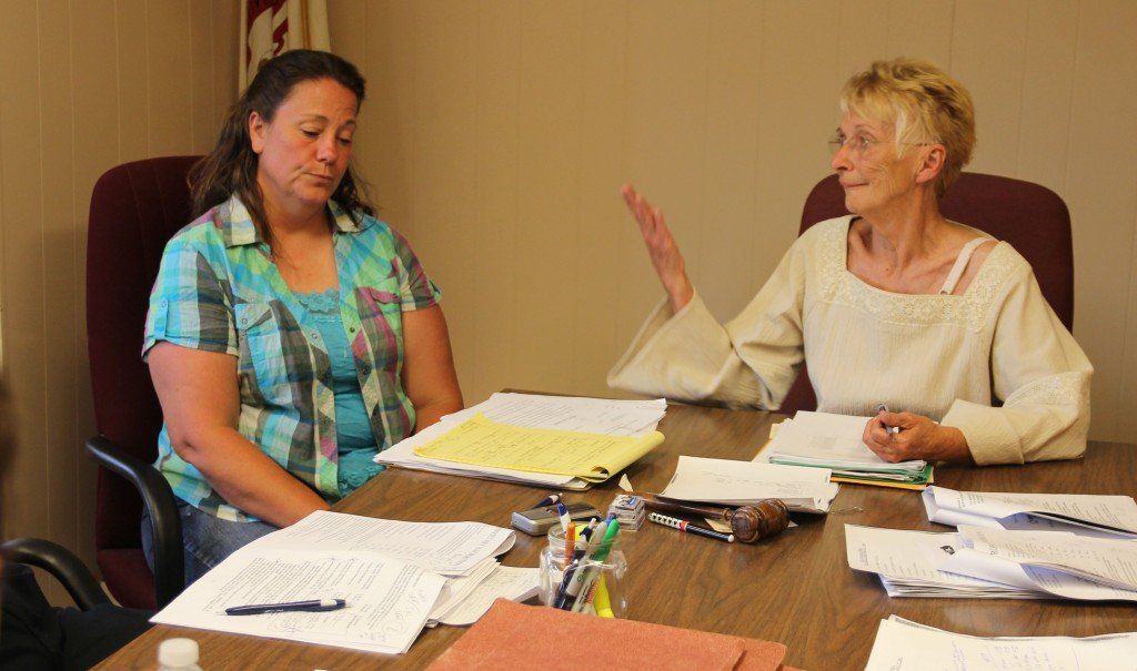 Mayor Gloria Sidar explains the city's approach to the city-wide trash service to the audience.