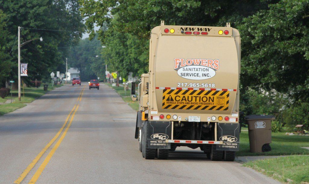 Flowers Sanitation hauls away trash from Elm Street last week. 