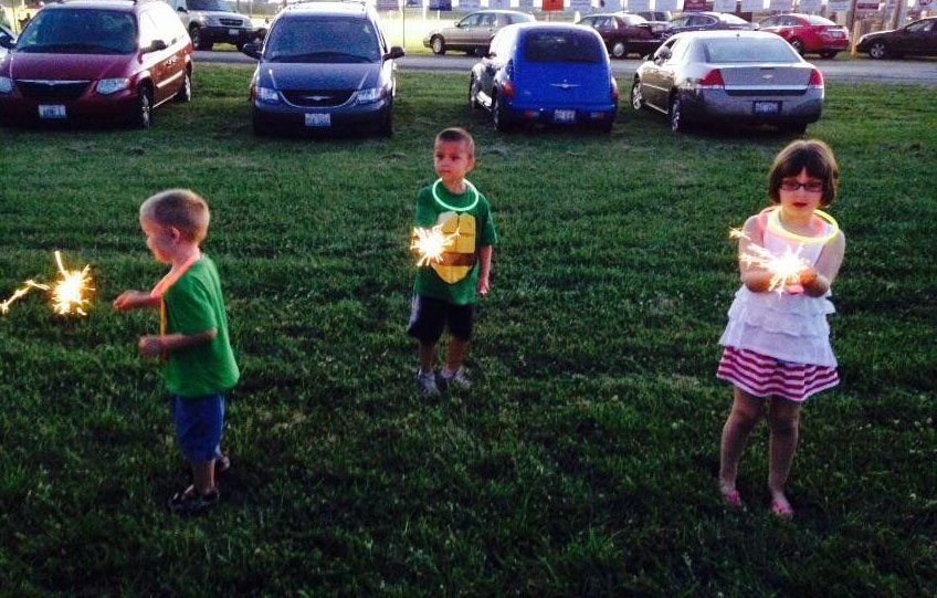 Children play with sparklers at the Coal Country Sports Complex while the sun went down as they awaited the firework display. 