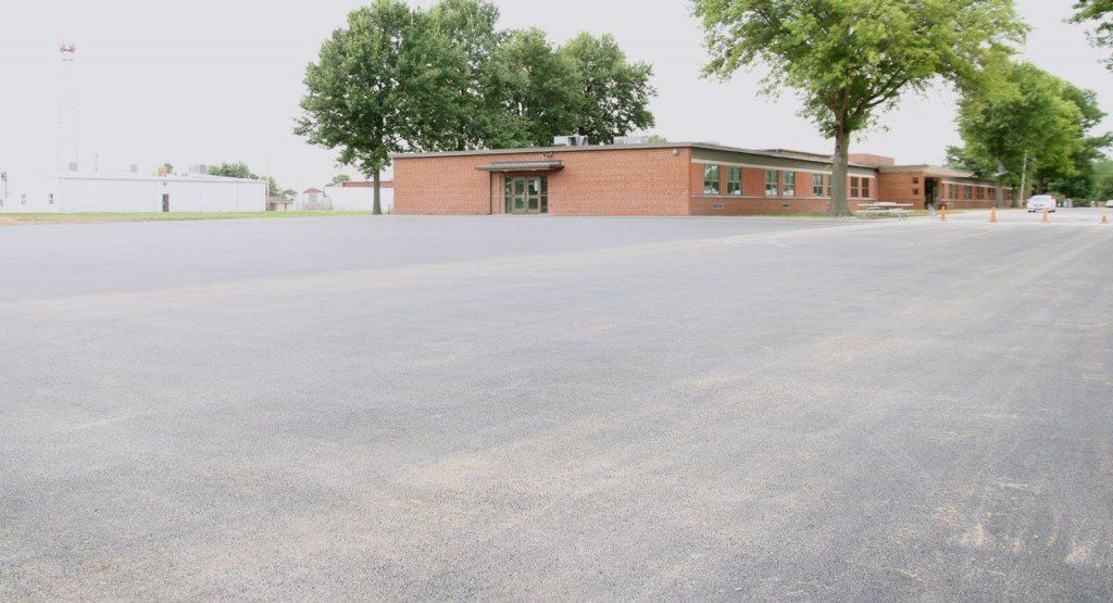 A look at the new asphalt playground that was finished this week. The playground will double as a parking lot for football games.