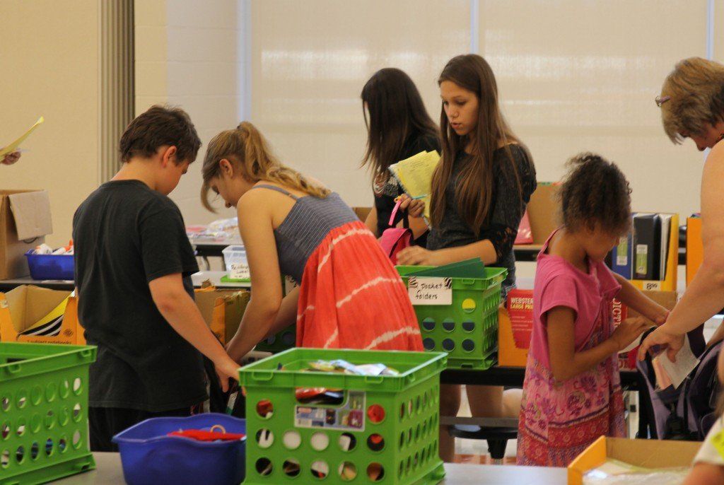 Volunteers help students shop for school supplies during Project Kid Kare this week. Nearly 200 students packed their book bags, read more about it here. 