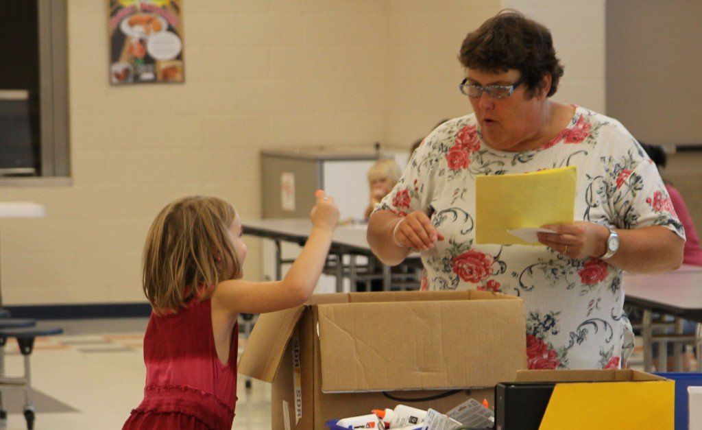 Lisa Demann held the supply list while a student shopped for her supplies during Project Kid Kare. The organization has been helping District 7 students for 15 years, read more here.  