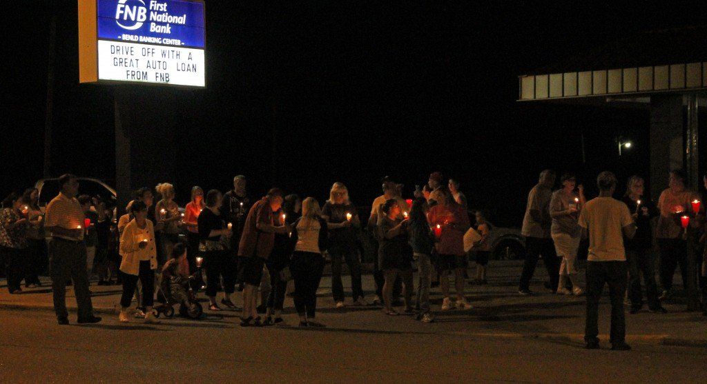Coworkers, family members and friends gather for a candle vigil following the sudden death of Kimberly Ann Mitchell, an employee of FNB Benld. Read her obituary here. 