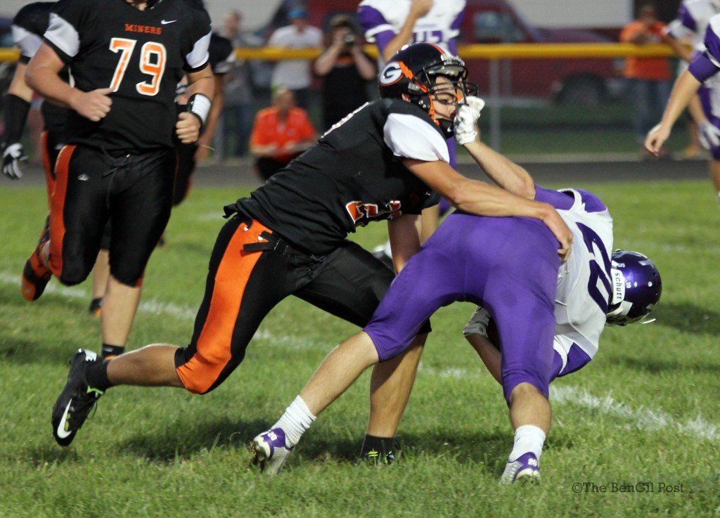 Alex Myers make a tackle in the backfield despite a hand in his face. The Miners dropped their second of the season last night, 30-44.