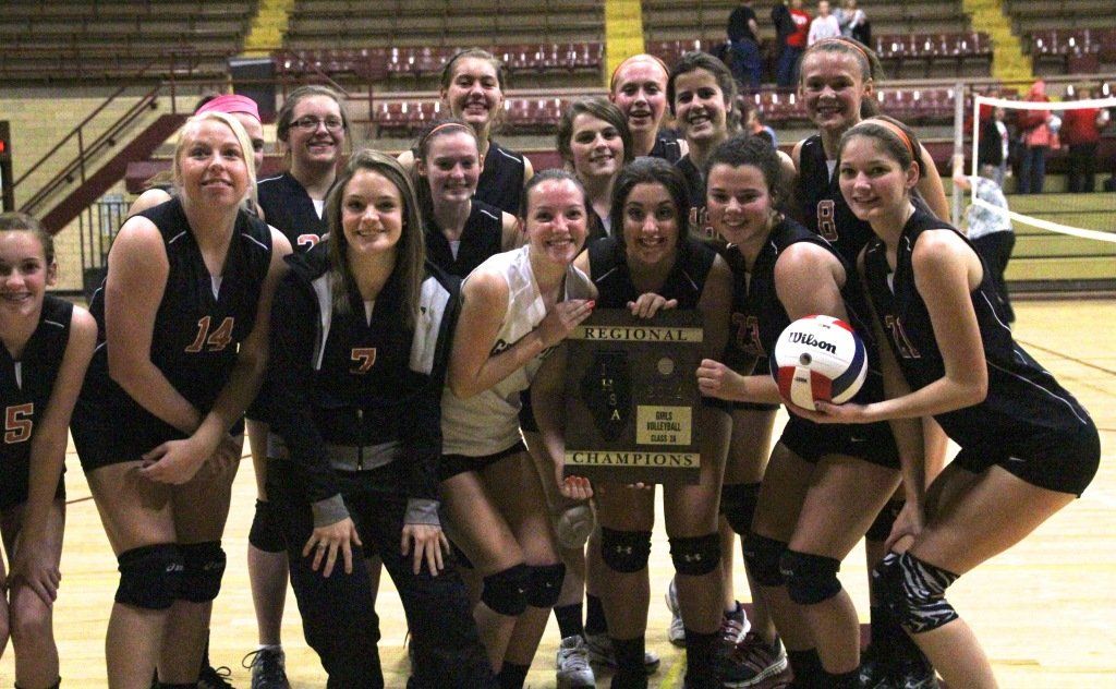 The volleyball team poses with their class 2A regional championship plaque. The volleyball team beat Staunton to win regionals. 