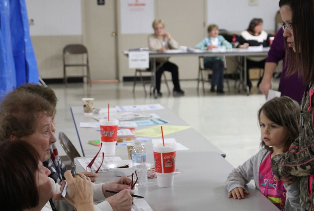 Election Day volunteers help citizens determine what township they live in. 