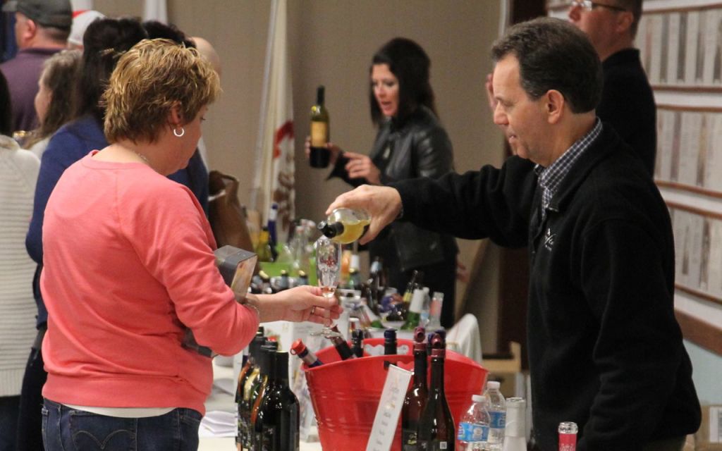 Citizens congregate and socialize over samples of wine and snacks at Benld Library's annual wine tasting which drew nearly 150 people. 