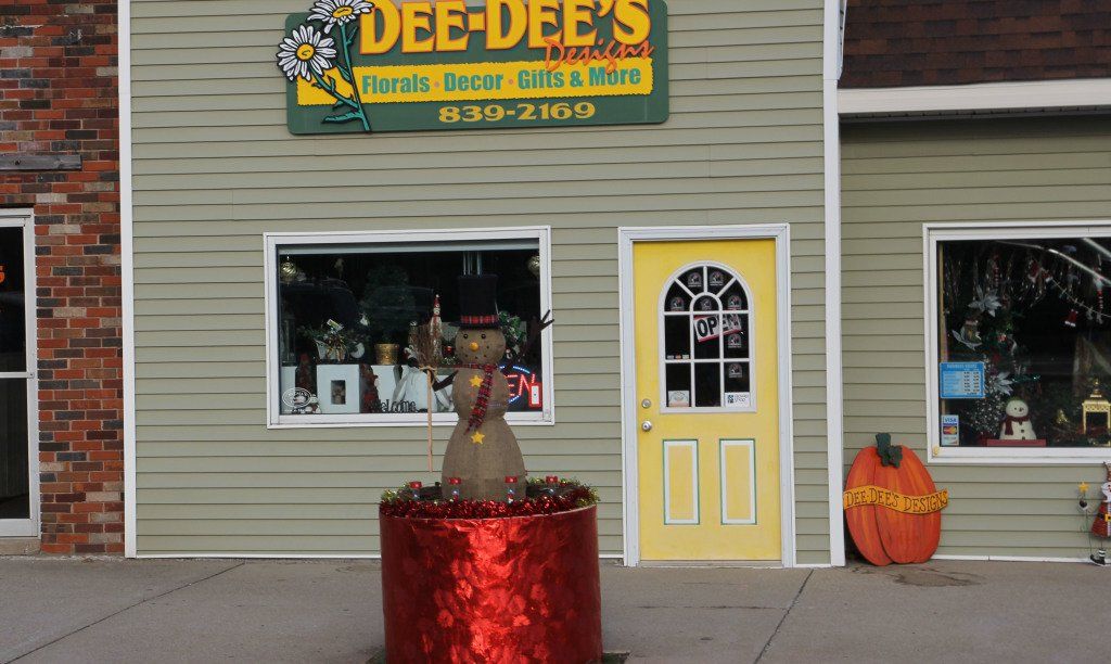 Volunteers who are competing to win the planter decorating contest starting decorating Gillespie's planters last week. The planter in front of Dee-Dee's Designs in Gillespie features a snowman, solar lights and a foil wrapped base. 