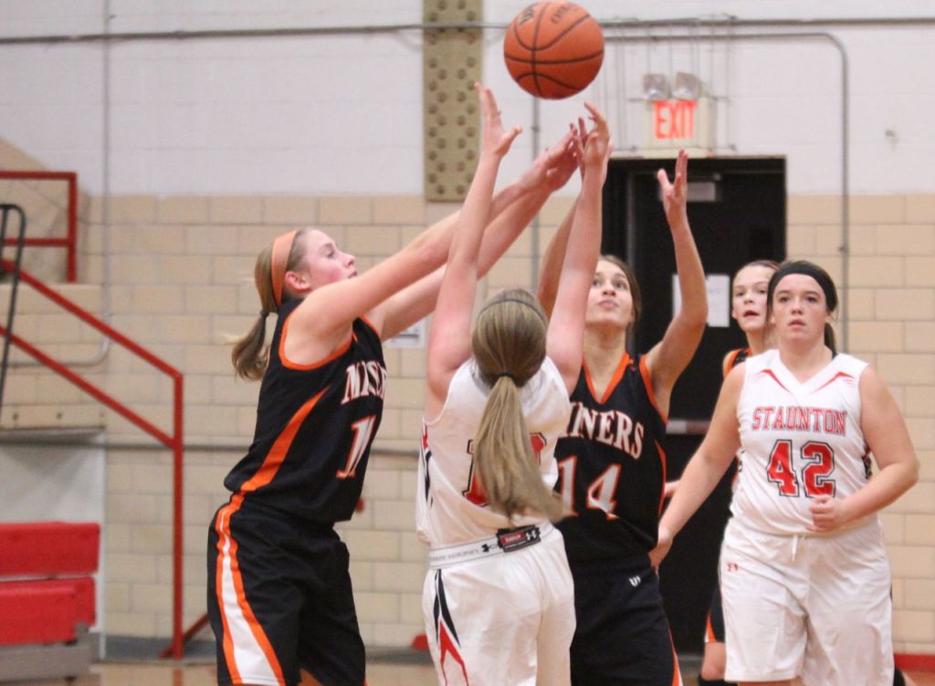 Abbie Barber and Amanda Schmidt compete with a Staunton player for possession of the ball. 