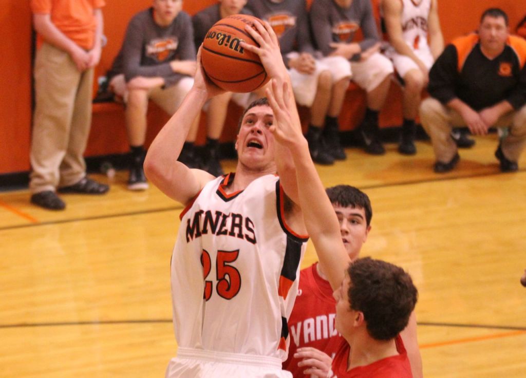Jacob Alepra knocks down the jump shot outside the paint area despite a hand in his face.