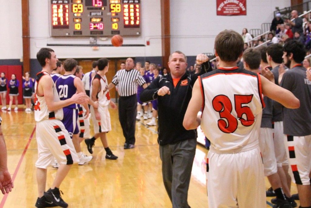 Matt Brawner reaches out to give Nick Price a fist bump after the Miners win the Carlinville Holiday Tournament championship. 