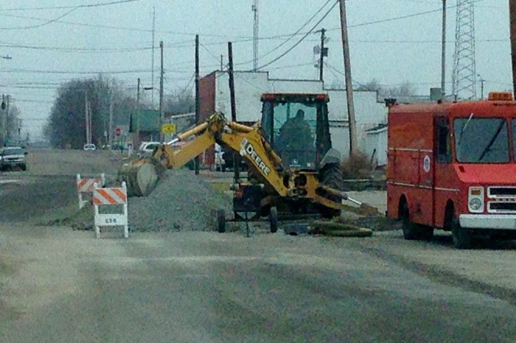Workers with the City of Gillespie fix a water break on Walnut Street last week. 