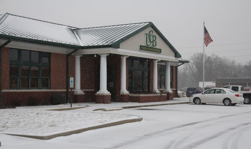 Snow covers the parking lot and grass of the United Community Bank in Gillespie last week. 