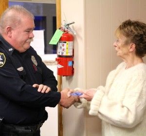Mayor Gloria Sidar, right, presents Officer Reno, left, with his corporal pins
