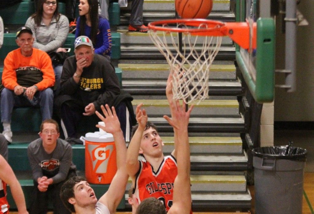 Josh Friese shoots and scores for Gillespie over Dupo Monday evening. Friese, a senior on the basketball team, played his last game Thursday. 