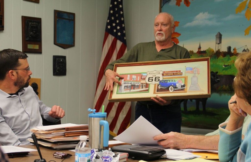 Gillespie Alderman Dave Tucker shows the council what will be painted on the side of Michelle's Pharmacy in Gillespie. The painting will be done by June 13. 