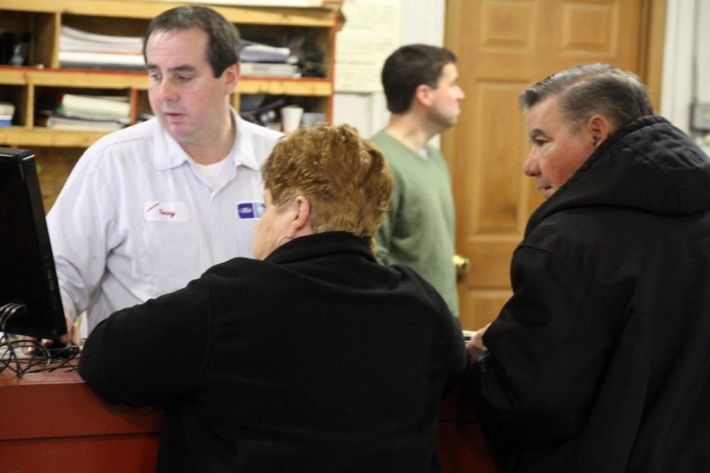 A service technician at Drew Ford talks with customers. 
