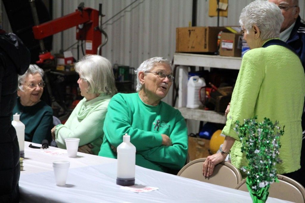 Jim Alderson (middle green shirt) chats with other customers after finishing his breakfast.